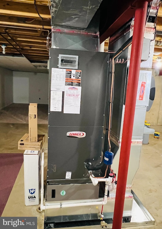 utility room featuring heating unit