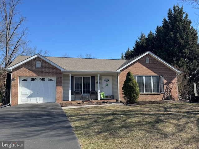 ranch-style house featuring an attached garage, covered porch, brick siding, driveway, and a front lawn