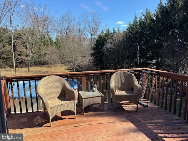 wooden terrace with a pool