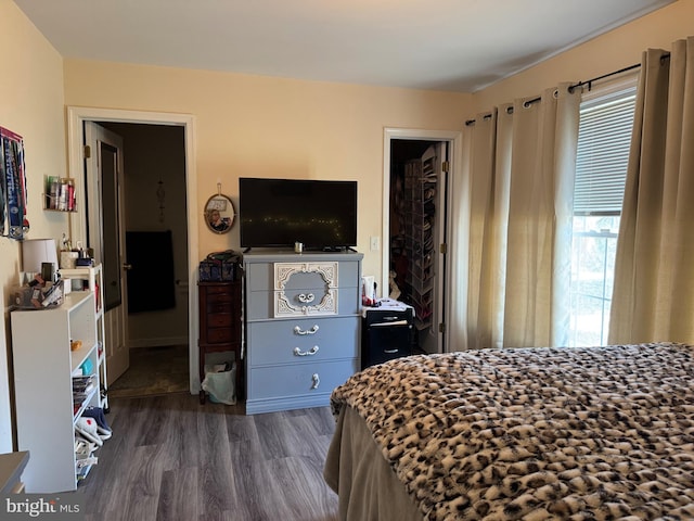 bedroom with dark wood-style flooring