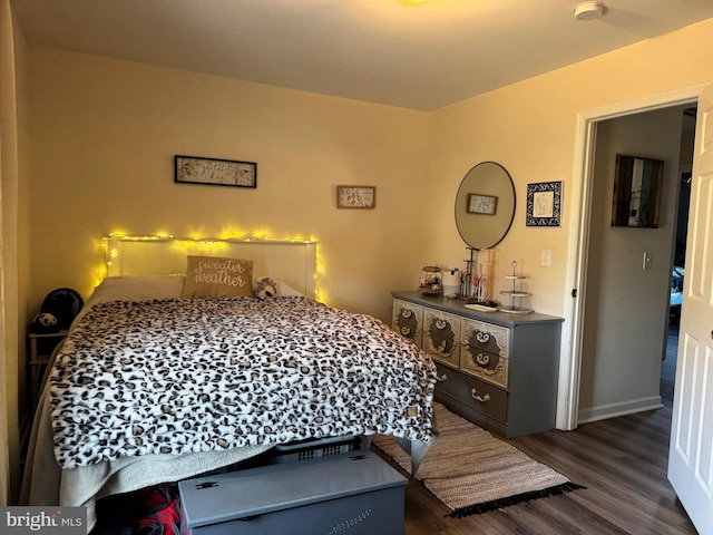 bedroom featuring dark wood-type flooring and baseboards