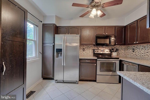 kitchen with light tile patterned floors, dark brown cabinets, appliances with stainless steel finishes, and decorative backsplash