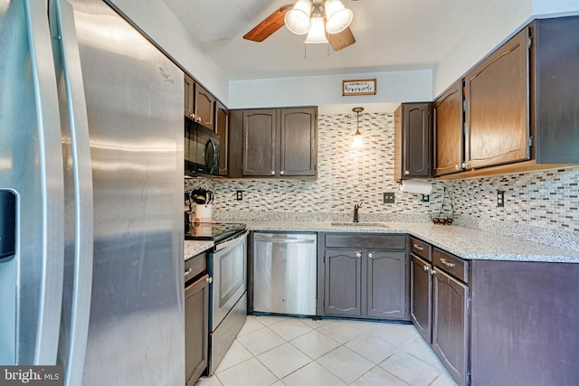 kitchen with appliances with stainless steel finishes, ceiling fan, decorative backsplash, and a sink