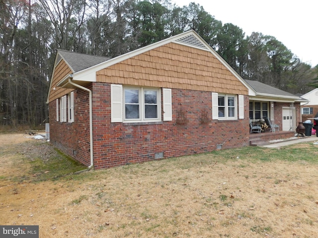 exterior space with a front lawn, brick siding, and crawl space