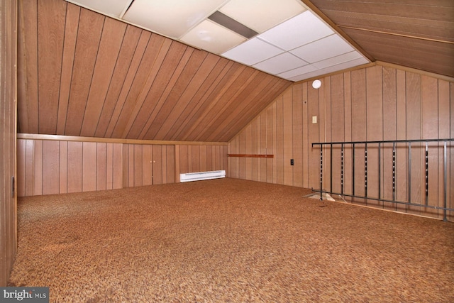 bonus room with vaulted ceiling, wood walls, and carpet floors