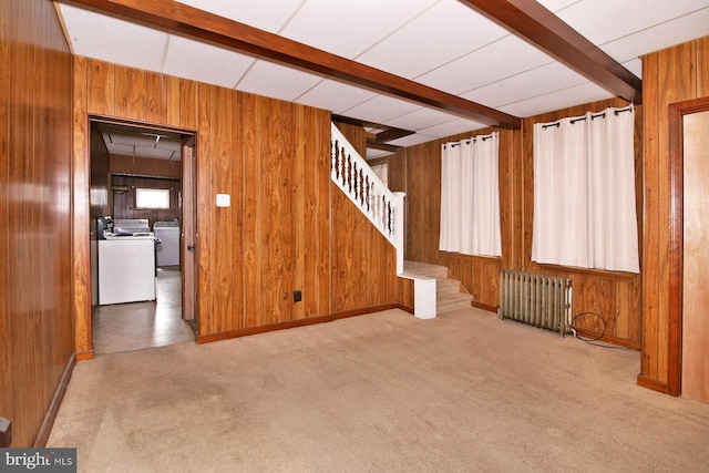 interior space with independent washer and dryer, radiator, wood walls, carpet flooring, and stairs