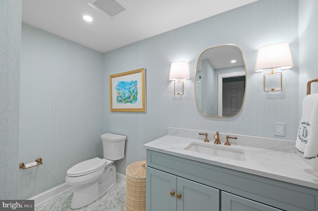 bathroom featuring vanity, baseboards, visible vents, recessed lighting, and toilet