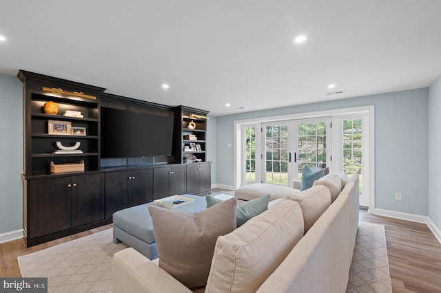 living room with recessed lighting, french doors, baseboards, and light wood finished floors