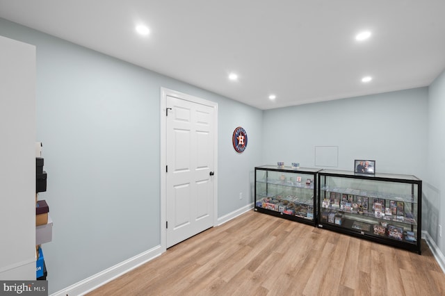 interior space with recessed lighting, wood finished floors, and baseboards