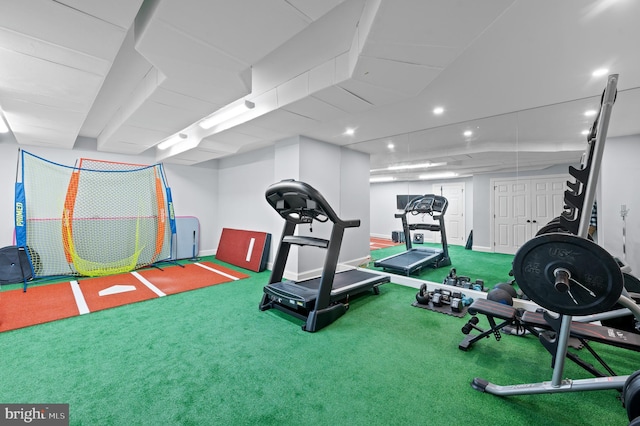 exercise room with baseboards and carpet