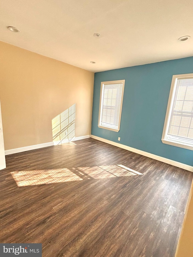 unfurnished room featuring wood finished floors and baseboards