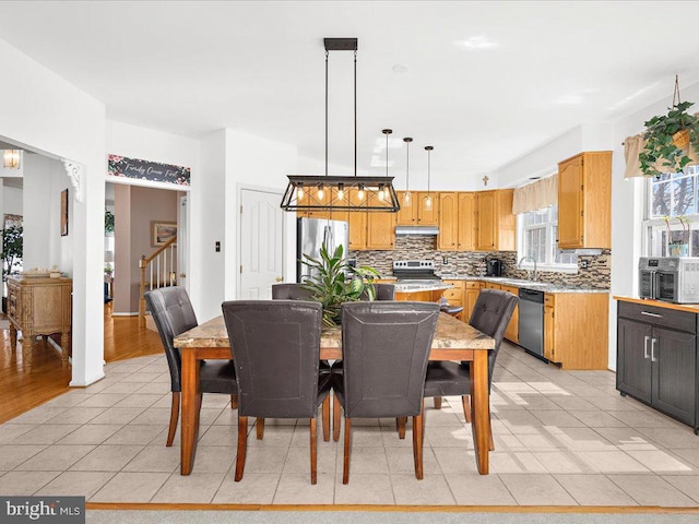 dining room featuring stairway and light tile patterned floors