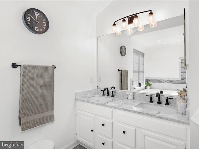 full bath featuring double vanity, a bathing tub, and a sink