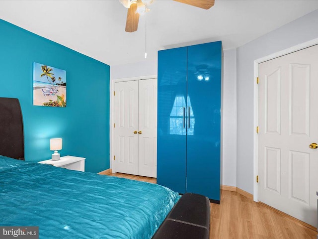 bedroom with baseboards, wood finished floors, and a ceiling fan