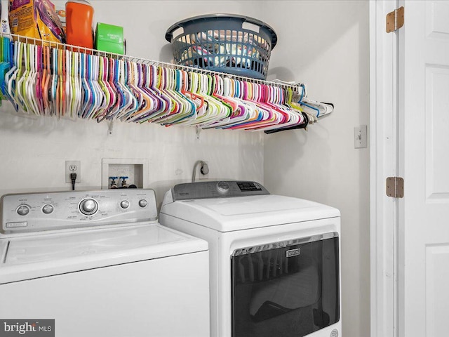 clothes washing area with washer and clothes dryer