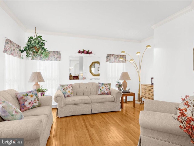 living room with light wood-style floors and ornamental molding