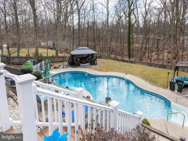 view of pool featuring a fenced backyard, a gazebo, a yard, a fenced in pool, and a patio area