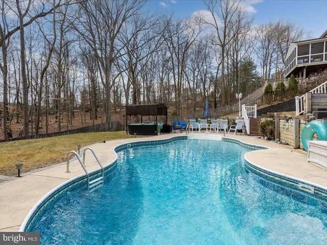 view of swimming pool featuring a patio, fence, a fenced in pool, and a hot tub