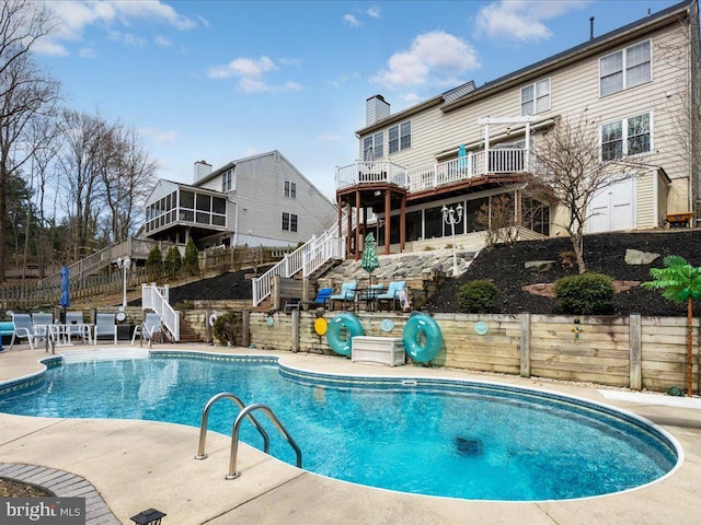 view of swimming pool with a fenced in pool, fence, stairs, and a patio area