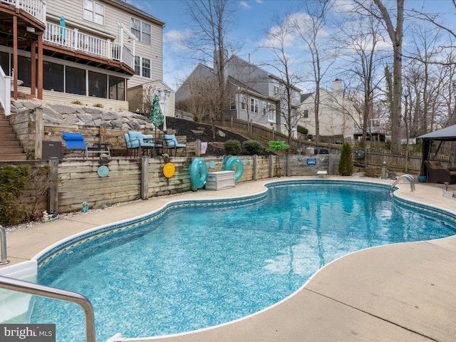 view of pool with a patio area, a fenced in pool, and fence