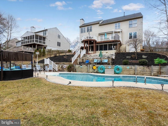 view of swimming pool featuring a lawn, fence, a fenced in pool, stairs, and a patio area