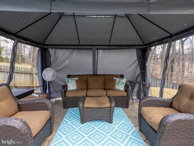 view of patio / terrace with outdoor lounge area, a gazebo, and fence