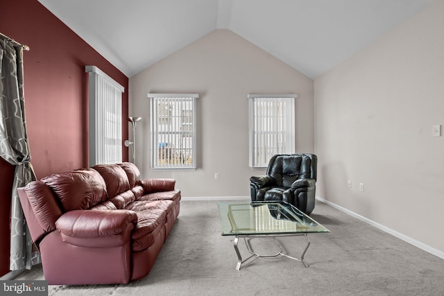 living area with baseboards, lofted ceiling, and carpet flooring