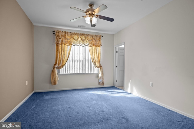 empty room featuring visible vents, baseboards, carpet, and a ceiling fan