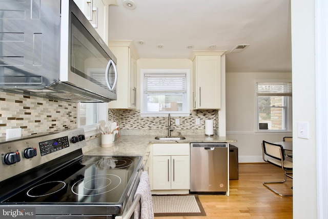 kitchen featuring plenty of natural light, visible vents, appliances with stainless steel finishes, and a sink