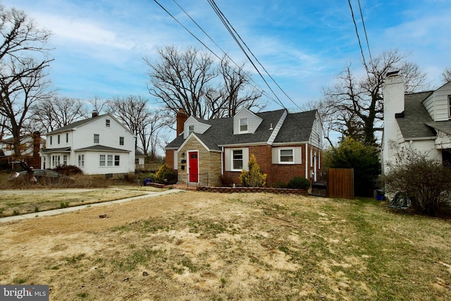 view of front of house with brick siding and a front yard