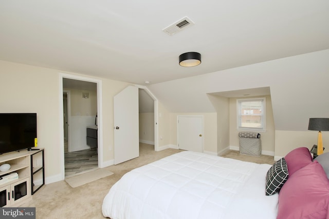 carpeted bedroom featuring visible vents, baseboards, and vaulted ceiling