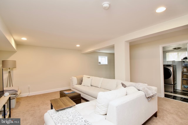 living room featuring recessed lighting, baseboards, light carpet, and washer / dryer