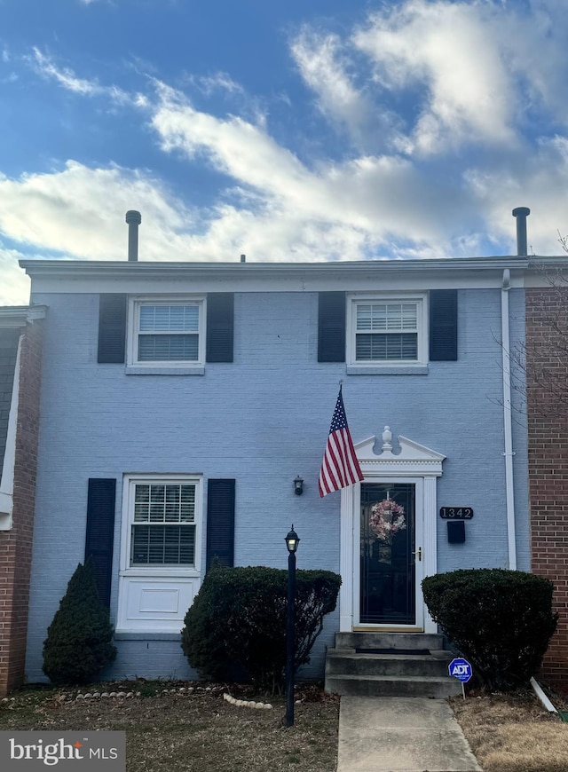 townhome / multi-family property featuring brick siding