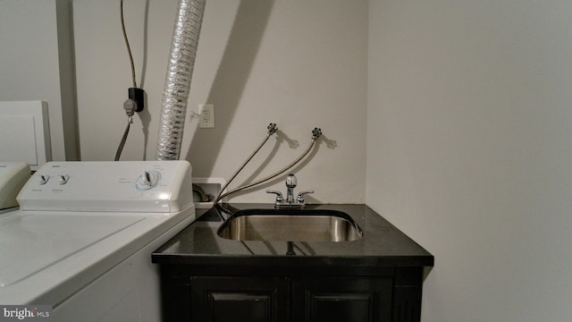 laundry area featuring washer / clothes dryer, cabinet space, and a sink