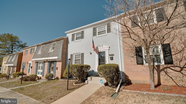 view of property featuring brick siding