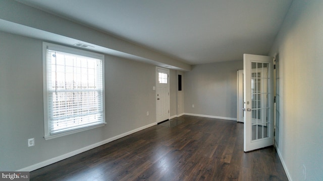 entrance foyer featuring visible vents, baseboards, and dark wood finished floors