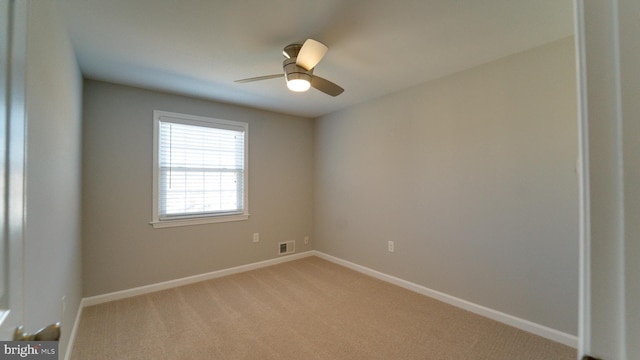 unfurnished room featuring baseboards, light colored carpet, and a ceiling fan