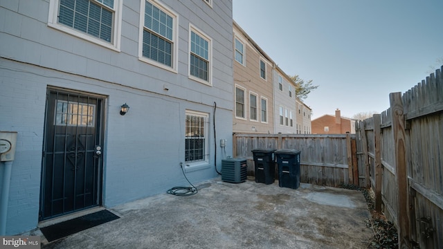 exterior space with central air condition unit and a fenced backyard