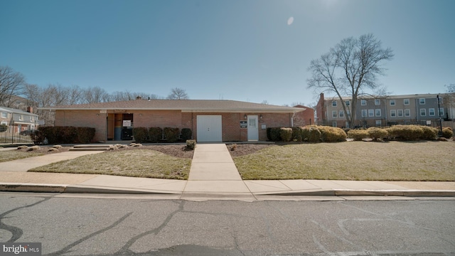 view of front of home with brick siding and a front yard