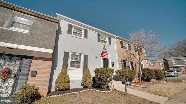 townhome / multi-family property featuring brick siding