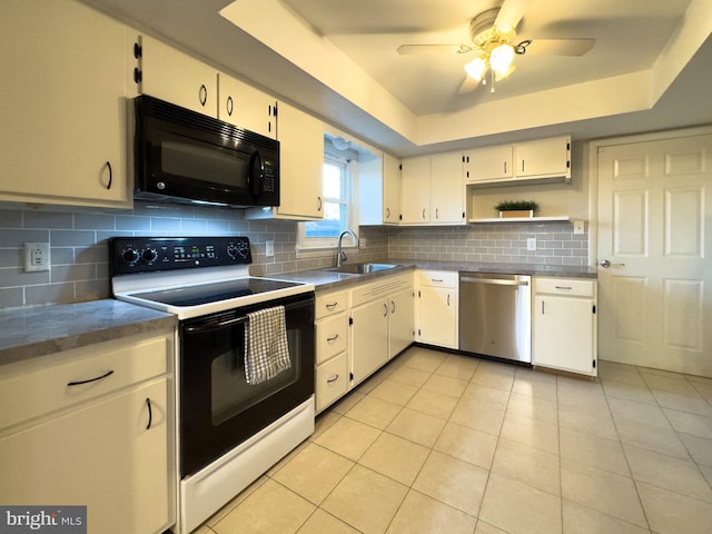 kitchen featuring stainless steel dishwasher, black microwave, a raised ceiling, and electric range oven