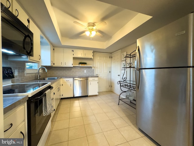 kitchen featuring tasteful backsplash, a tray ceiling, black appliances, open shelves, and a sink