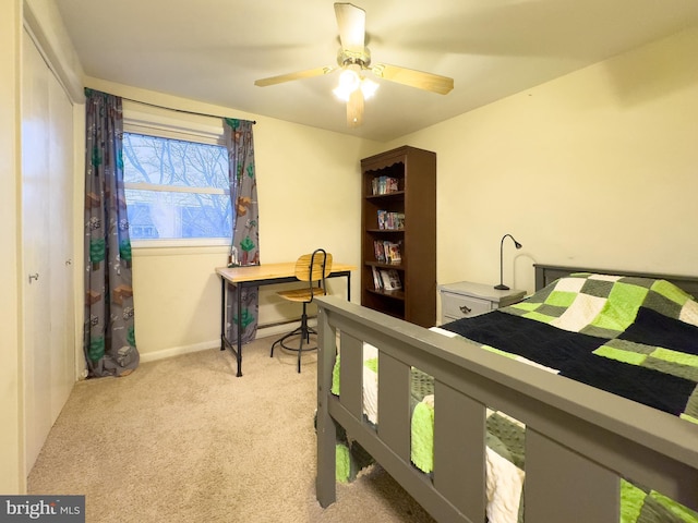 bedroom with a ceiling fan, a baseboard radiator, light colored carpet, and baseboards