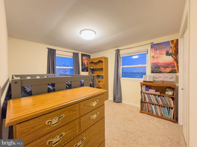 interior space featuring light carpet and baseboards