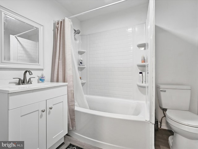 full bathroom featuring shower / bath combination with curtain, vanity, and toilet