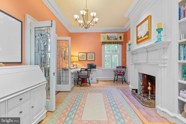 office space with a fireplace with flush hearth, a notable chandelier, light wood-style flooring, and crown molding