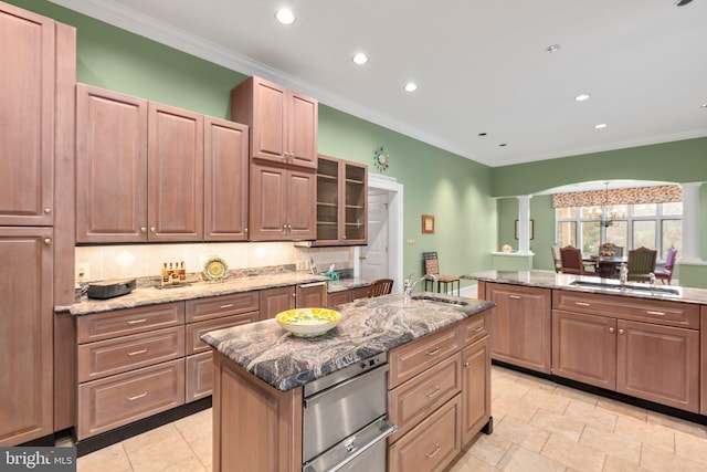 kitchen with stone countertops, a kitchen island, and recessed lighting