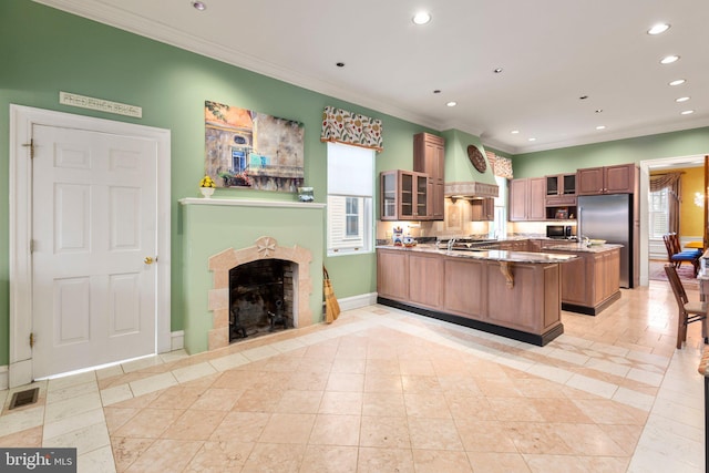 kitchen with stainless steel built in fridge, recessed lighting, a peninsula, crown molding, and custom exhaust hood