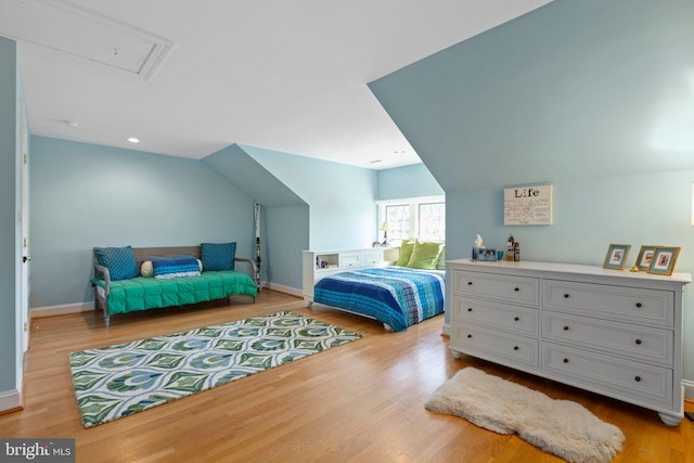 bedroom with wood finished floors, baseboards, lofted ceiling, attic access, and recessed lighting