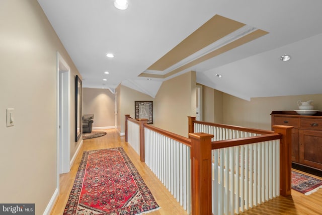 hall featuring recessed lighting, light wood-type flooring, baseboards, and vaulted ceiling